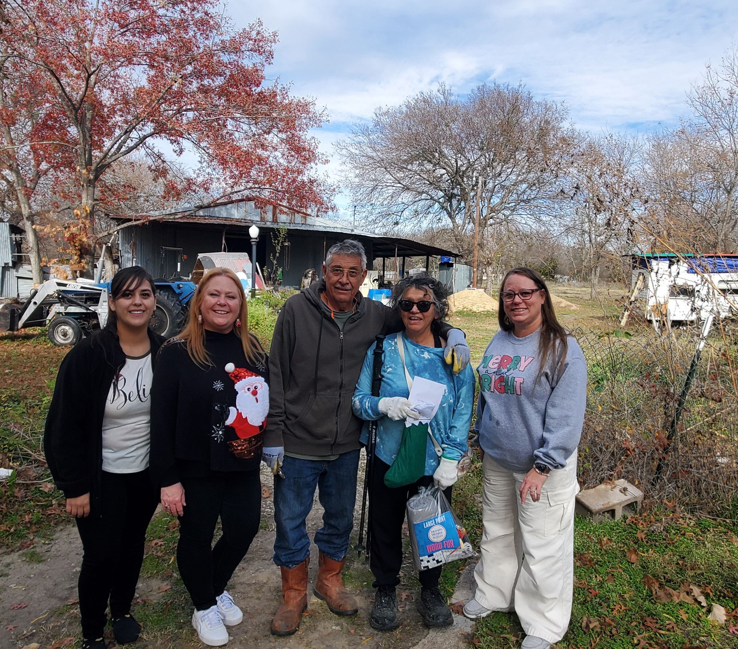 City Employees deliver Stockings for Seniors and pose with a recipient