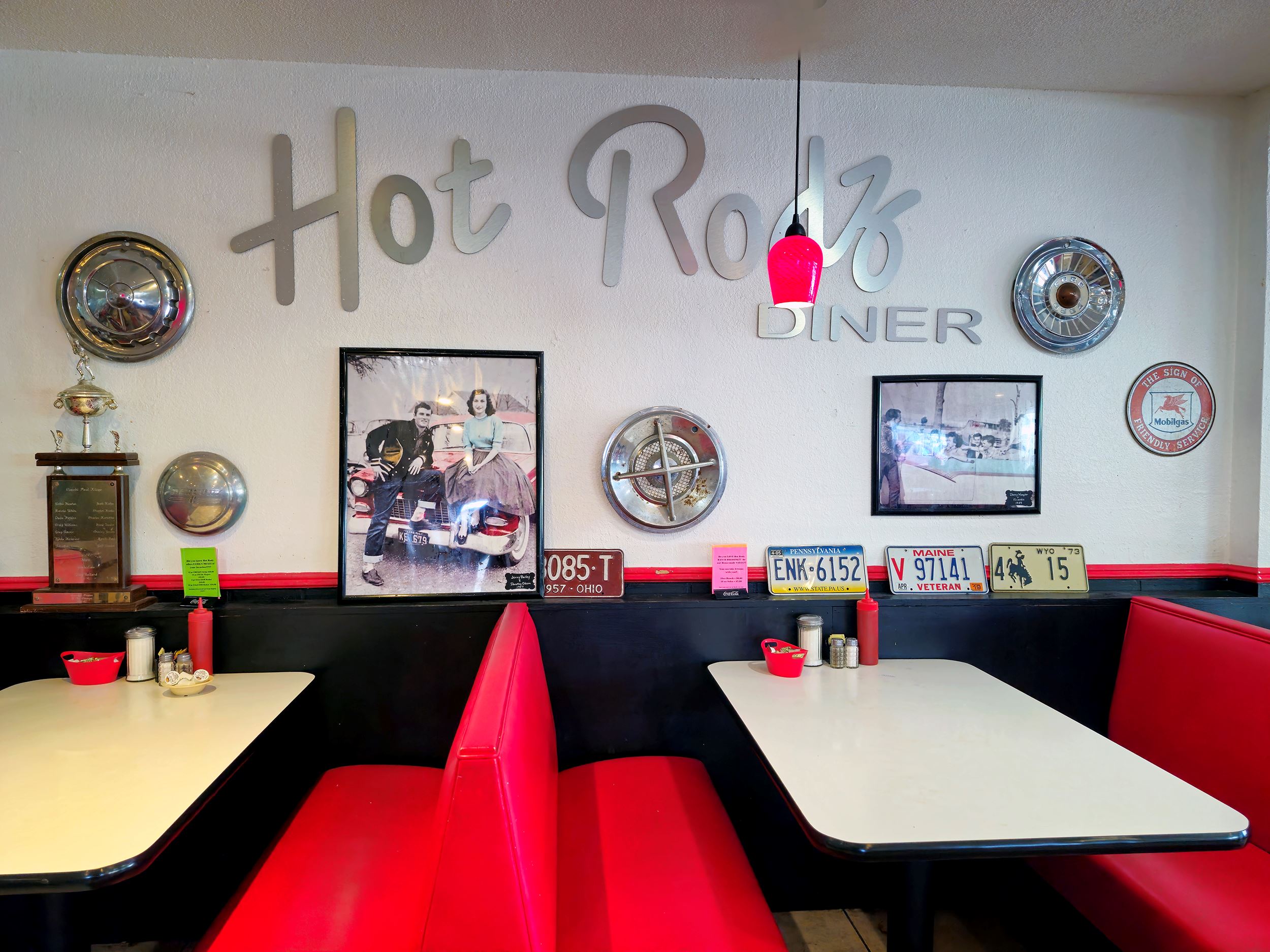 Booth seating in front of the Hot Rodz Diner lettering on the wall