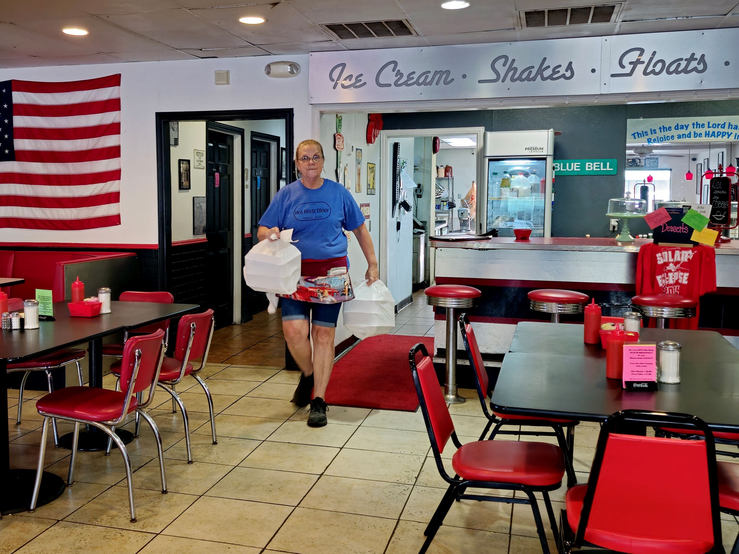 Rita bringing take out to customer at Hot Rodz Diner