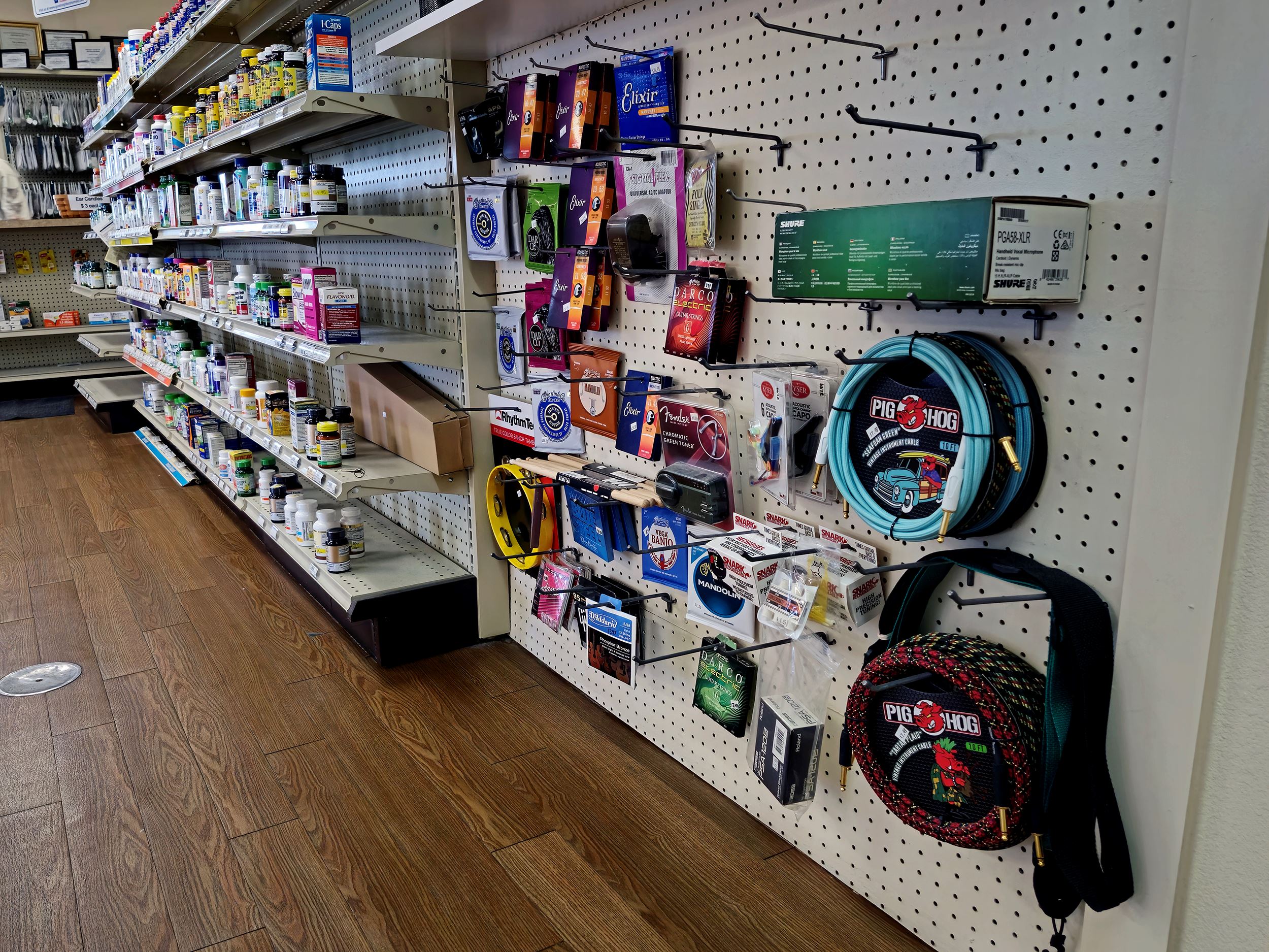 Selection of guitar and instrumental supplies at the end of a row of vitamins