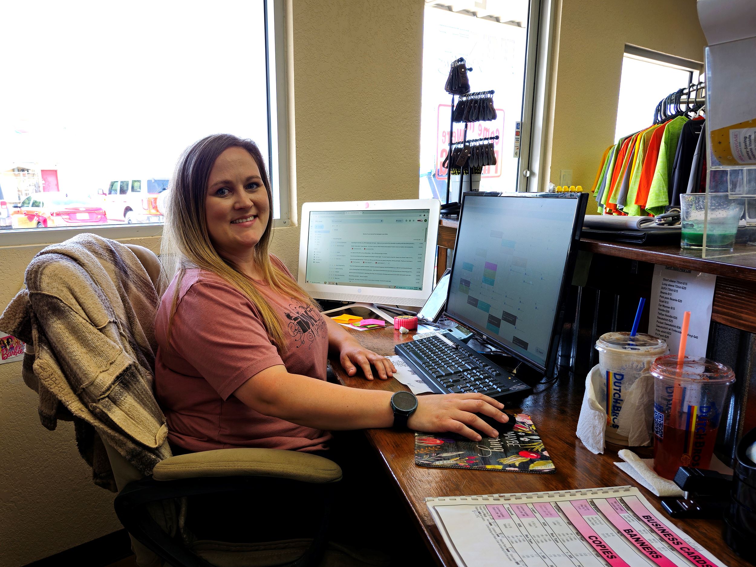 Friendly receptionist sitting at computer at Ink It Printing