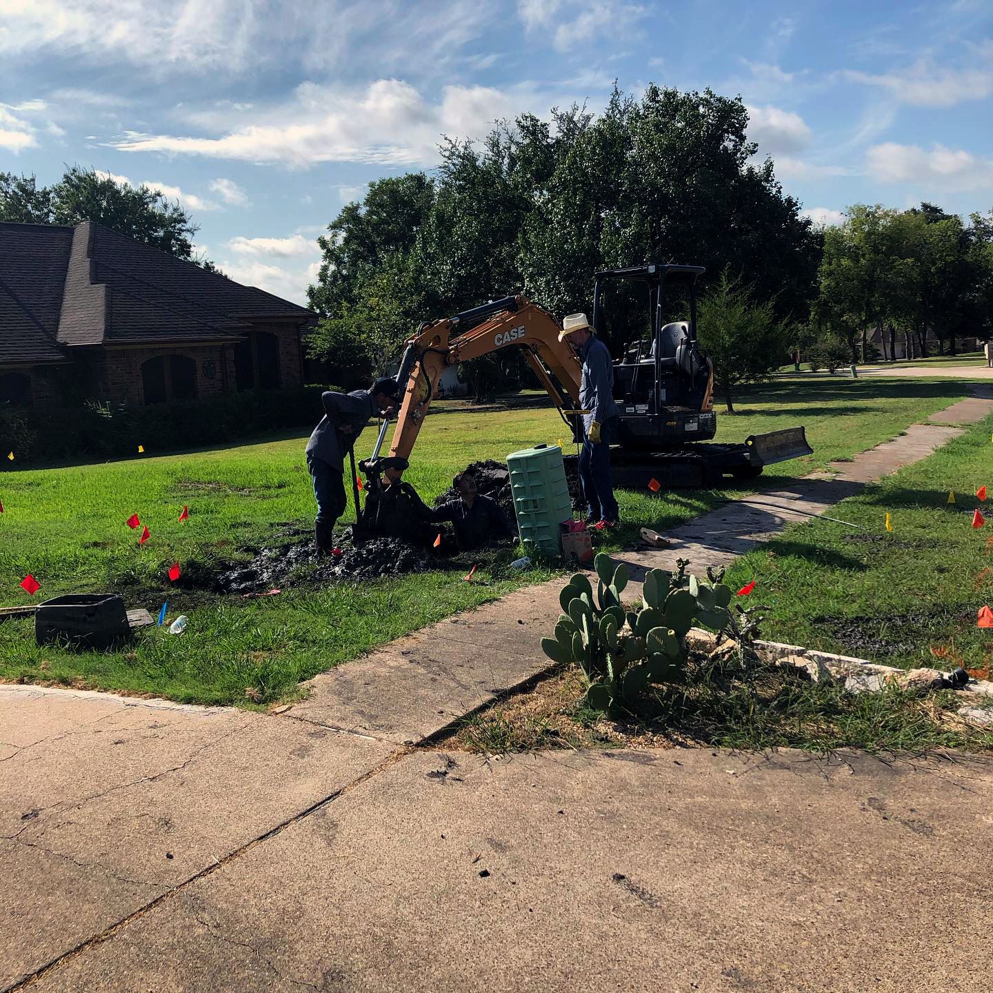 Public Works crew fixing a line in front of a house